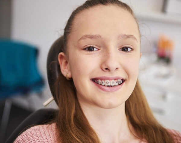 Portrait of smiling child with braces in dentist's office